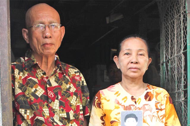 U Thaung Sein and Daw San Myint with a picture of their jailed son, Ko Aye Aung