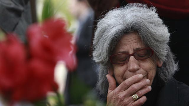 A woman cries at the spot where Dimitris Christoulas killed himself