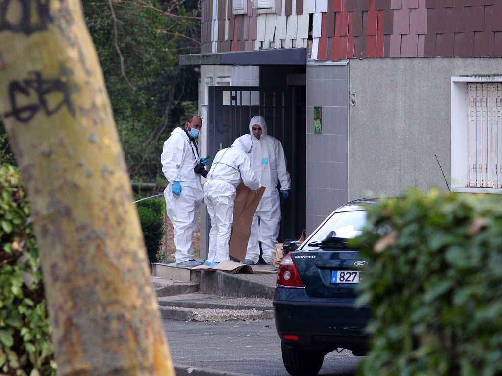 Members of the forensic service of the French police work near the building where a 47 years old woman was shot in the head by a gunman who escaped on a motorcycle on April 5
