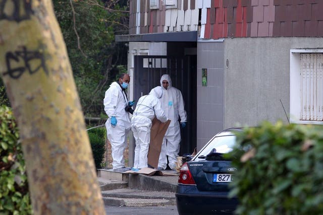 Forensic detectives look for clues at the flats in Grigny where a woman aged 47 was shot on Thursday