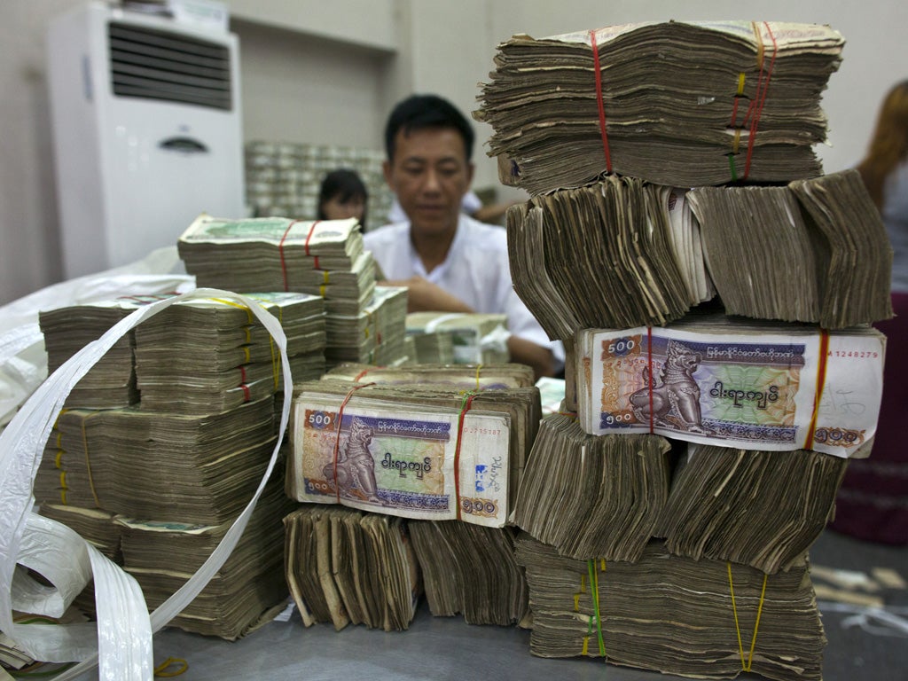 Workers count Burmese kyat currency at a bank in Rangoon.
Washington said this week it would begin lifting some sanctions on what the IMF calls 'the next economic frontier in Asia'