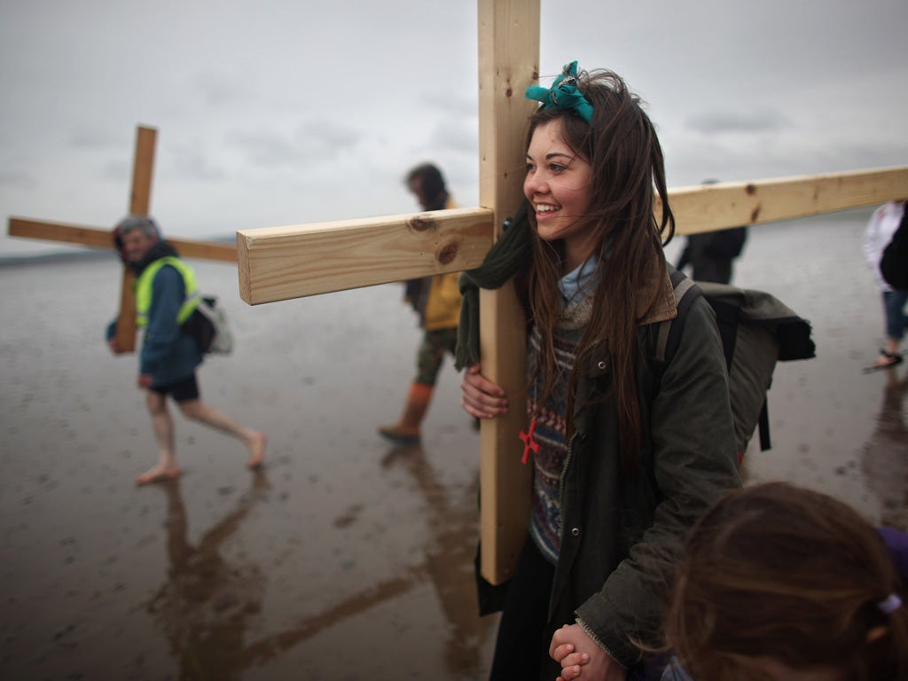 As millions scrambled by car, plane and train for the Easter break, some braved the weather on foot for a more traditional outing. More than 60 people, young and old, crossed the tidal causeway to Holy Island to observe the annual Christian pilgrimage