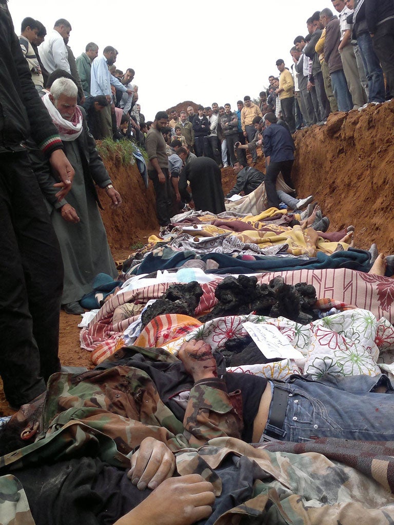 Mass grave: Syrians 'killed by government troops' are laid to rest in Taftanaz village last week