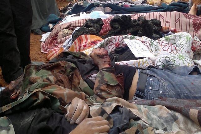 Mass grave: Syrians 'killed by government troops' are laid to rest in Taftanaz village last week