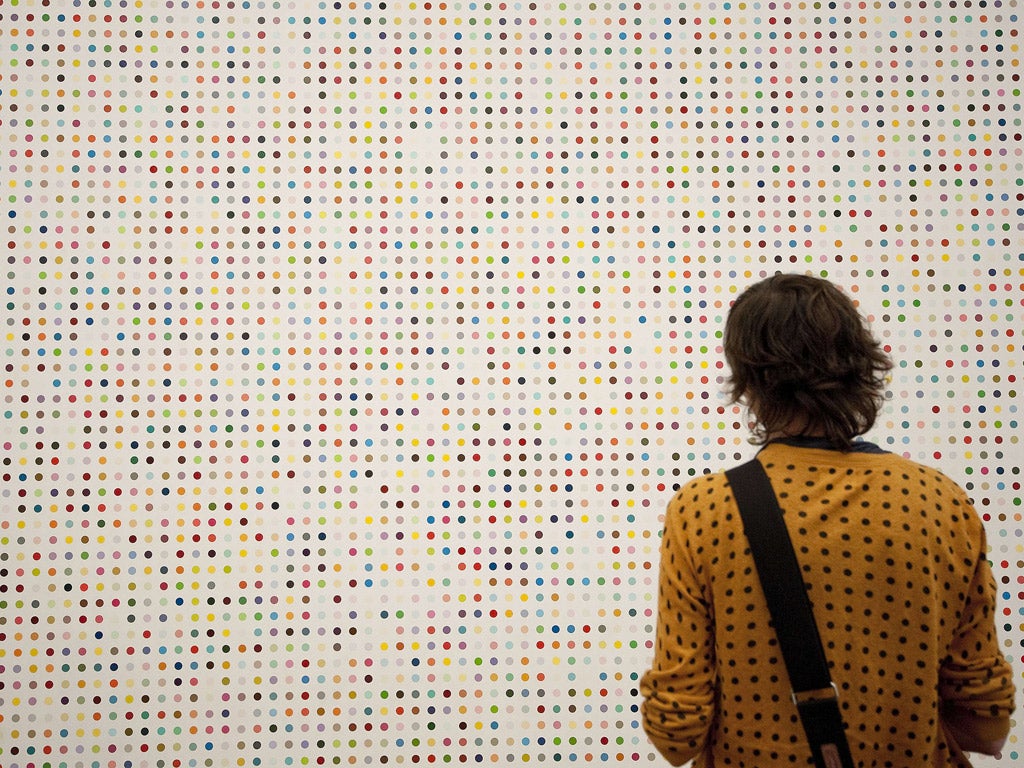One of Hirst's sought-after Spot paintings catches a visitor's eye at Tate Modern