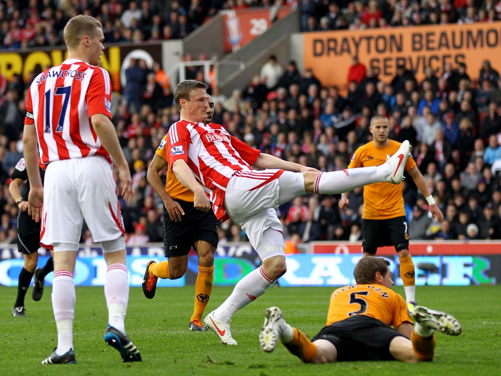 Star in stripes: Robert Huth smashes in the Stoke equaliser in a hard-fought derby against Wolves last night