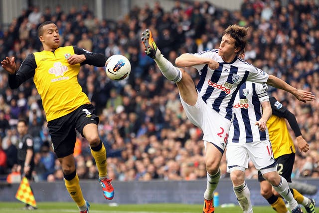 Boots Flying: Martin Olsson of Blackburn and West Bromwich's Billy Jones battle for the ball