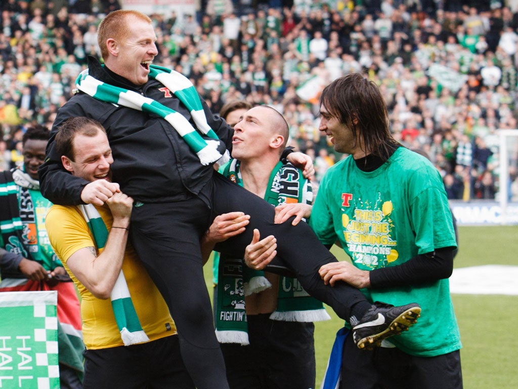 Happy Hoops: Celtic manager Neil Lennon gets a lift from Anthony Stokes, Scott Brown and Georgios Samaras after the club clinch the Scottish Premier title