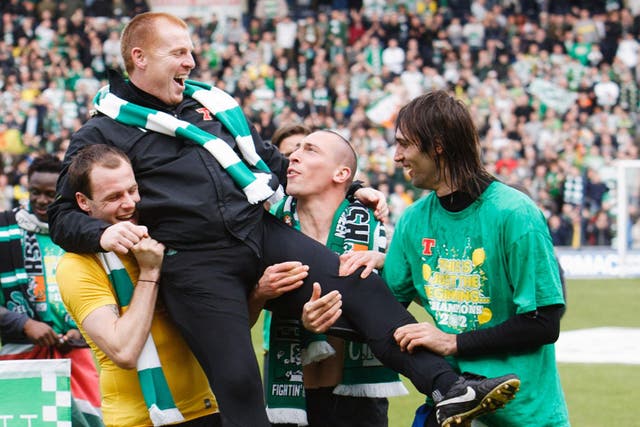 Happy Hoops: Celtic manager Neil Lennon gets a lift from Anthony Stokes, Scott Brown and Georgios Samaras after the club clinch the Scottish Premier title