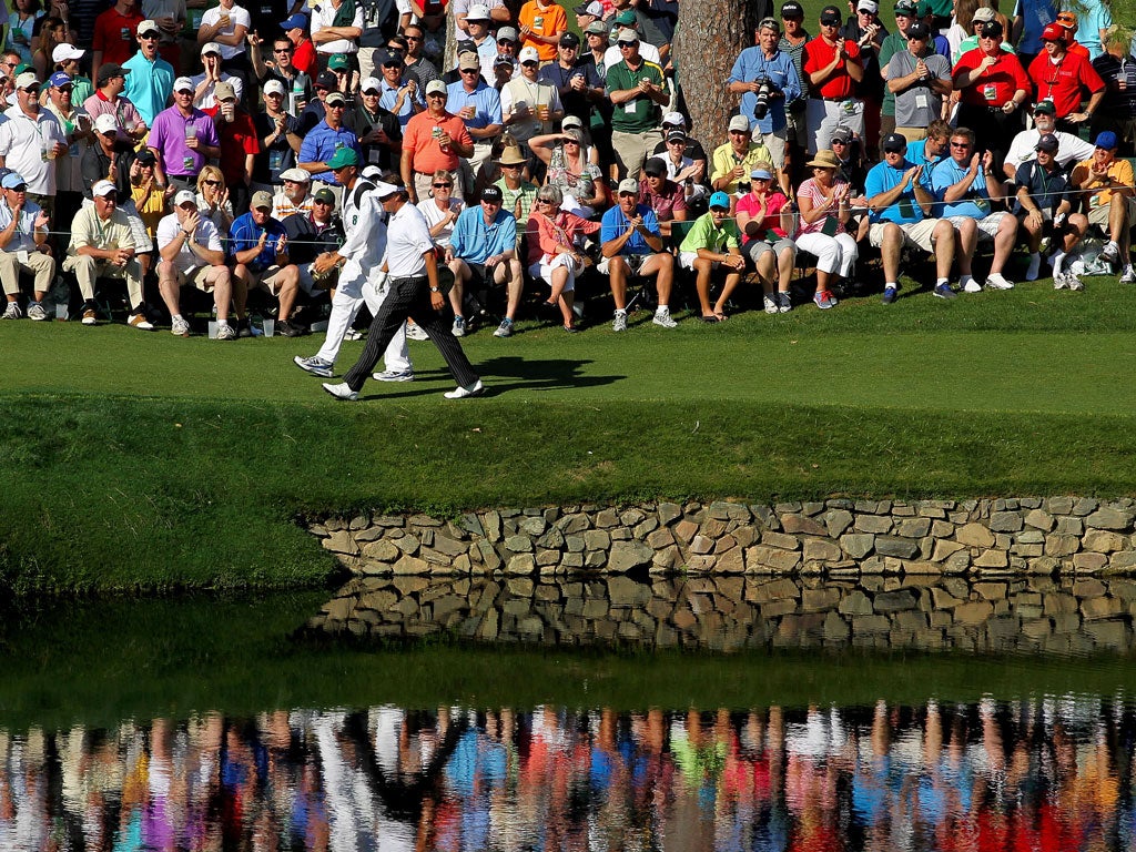 Phil Mickelson marches on to the 15th hole during his third round of 66 yesterday