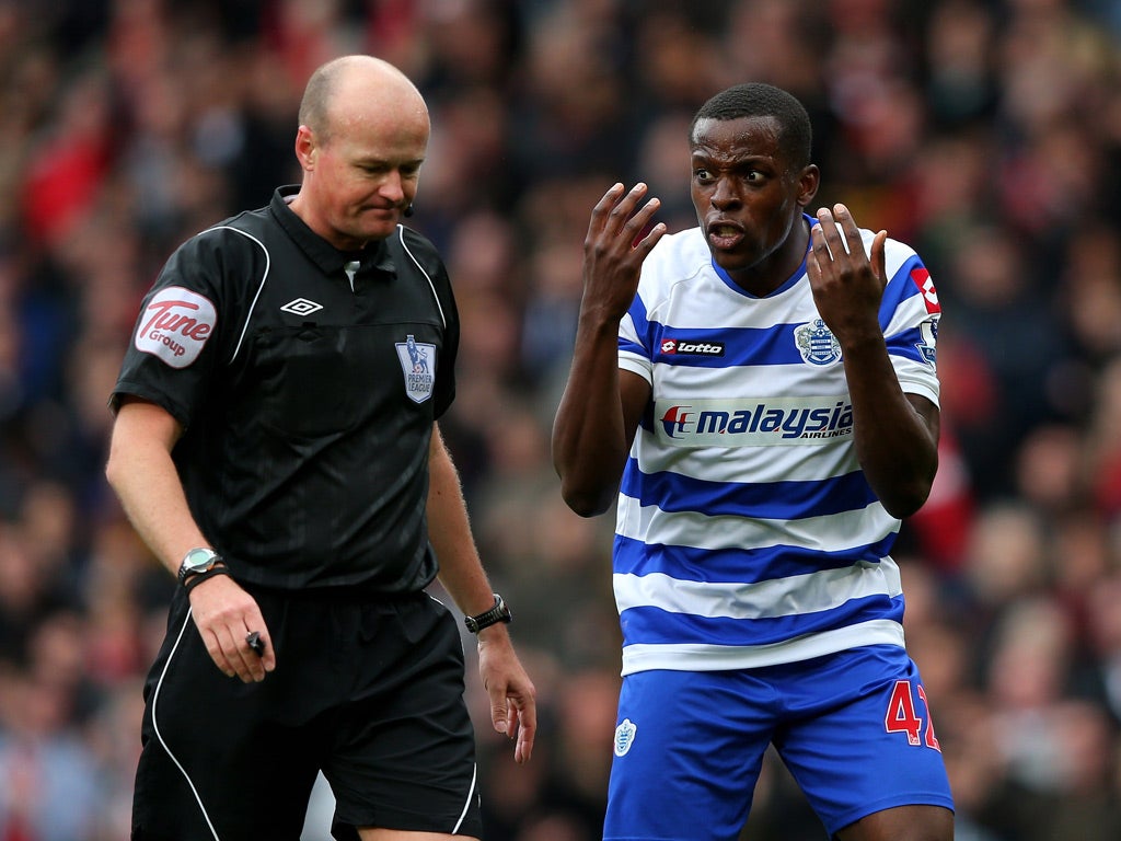 Nedum Onuoha of Queens Park Rangers protests to Referee Lee Mason after he awarded a controversial penalty to Manchester United