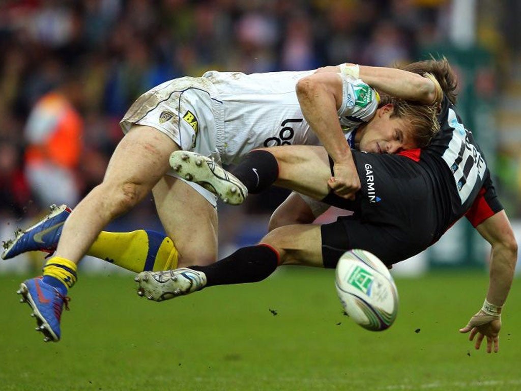 Clermont’s Aurélien Rougerie tackles Chris Wyles at Vicarage Road yesterday