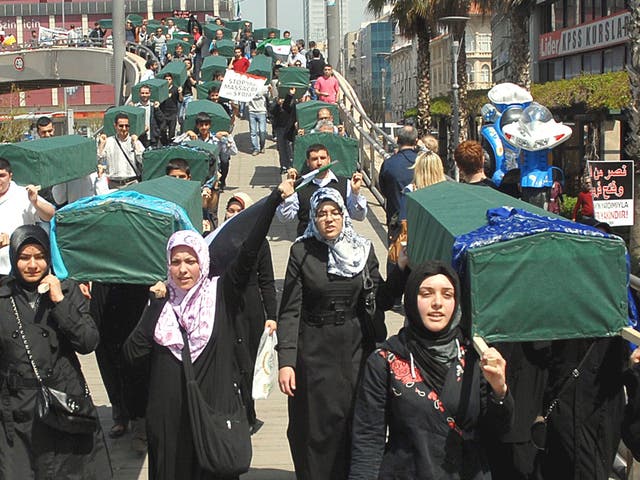 Demonstrators carry mock coffins at a protest in Izmir