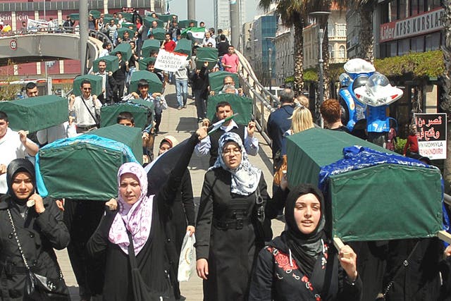 Demonstrators carry mock coffins at a protest in Izmir