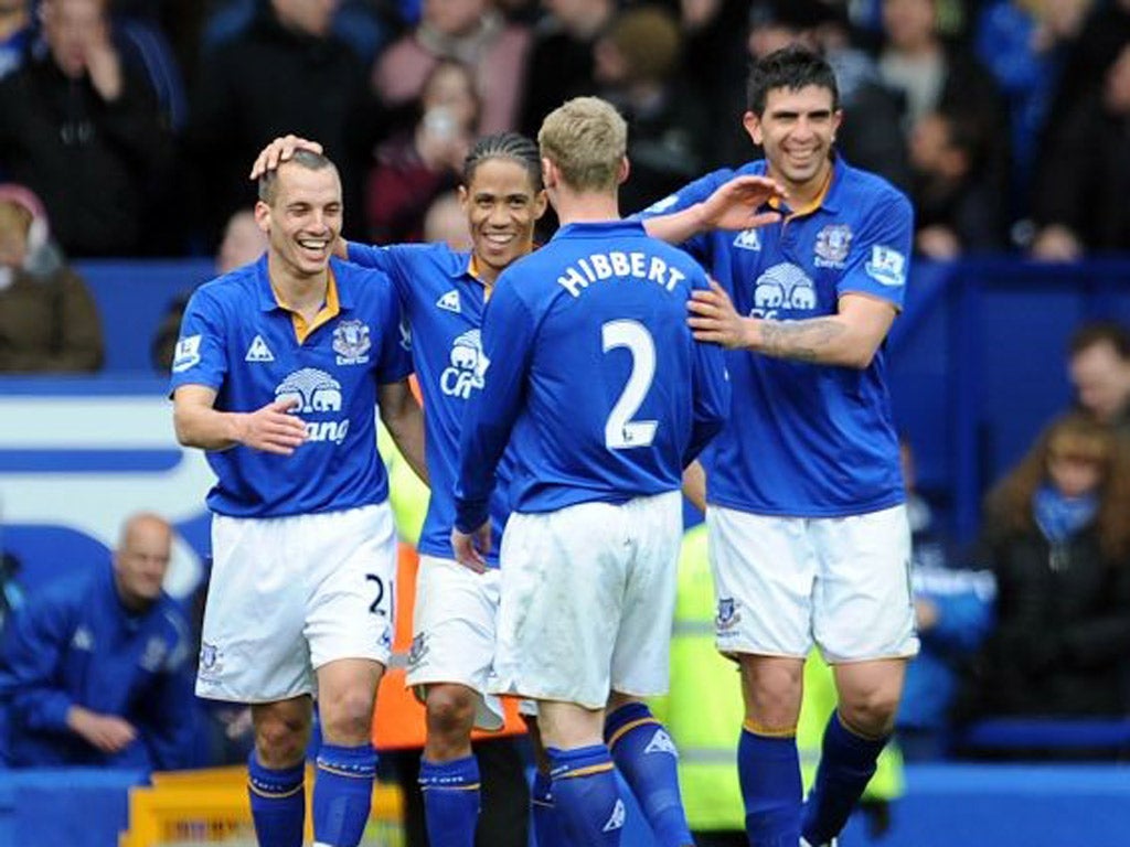 Everton's Leon Osman, left, celebrates with his team-mates after scoring Everton's third goal