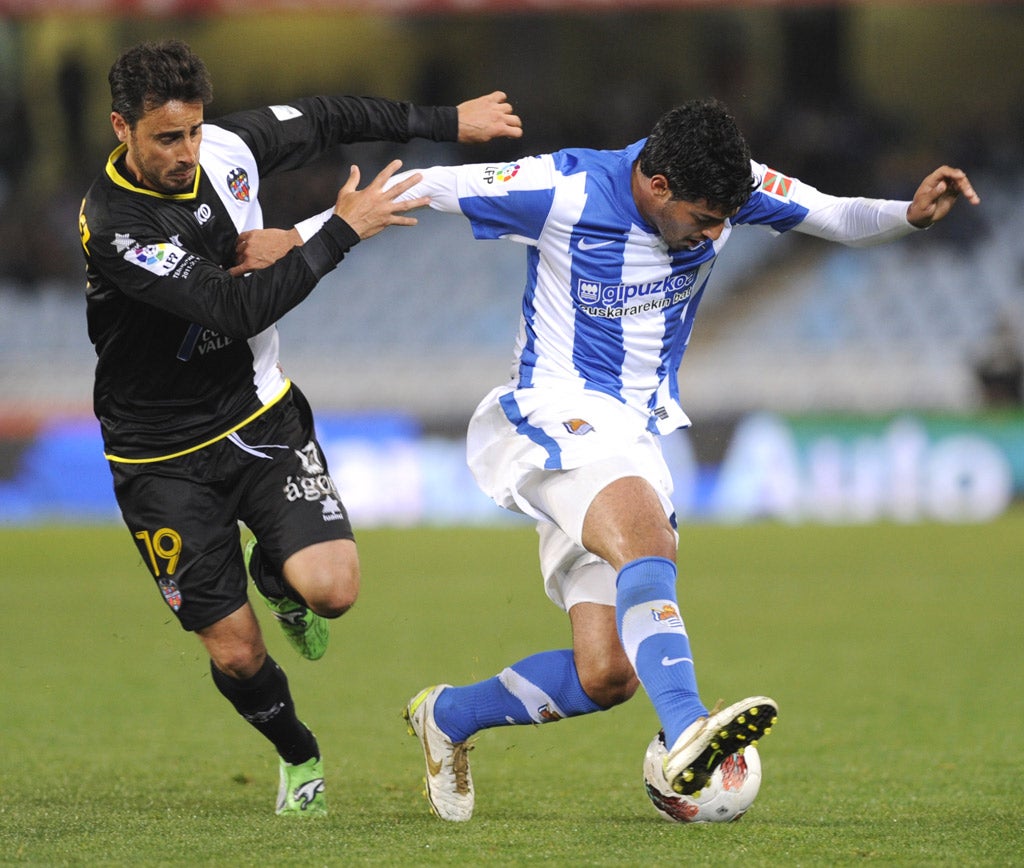 Real Sociedad's on-loan Arsenal striker Carlos Vela, right, would prefer to stay in Spain