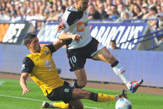Jason Lowe challenges Bolton’s Martin Petrov in last month’s derby
