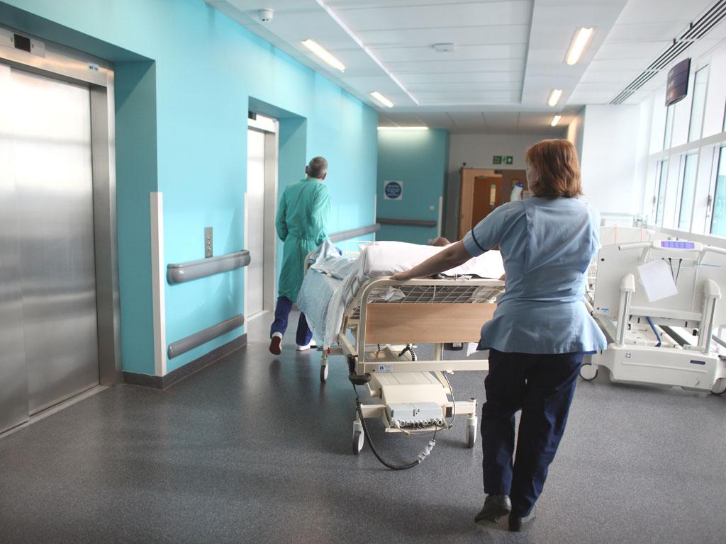 A nurse at Queen Elizabeth Hospital in Birmingham helps to move a patient. Many people complain of poor
treatment at hospitals