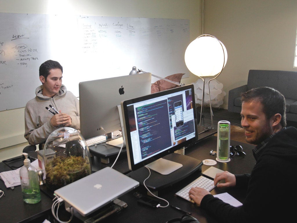 In this April 7, 2011 photo, CEO Kevin Systrom, at left, works alongside engineer Shayne Sweeney at Instagram in San Francisco