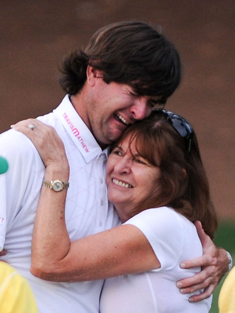 Bubba Watson is hugged by his mother Molly as he breaks down in tears after winning the 76th Masters tournament.