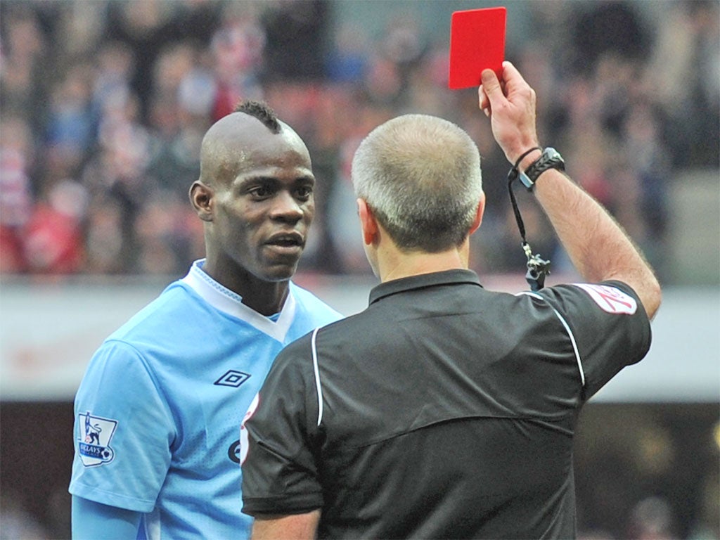 Mario Balotelli is shown red by Martin Atkinson after his stamp on Arsenal's Alex Song