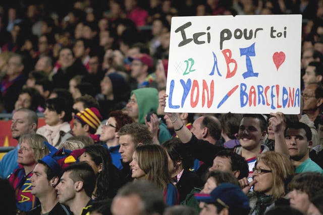 Barcelona fans hold a placard with a message of support for Eric Abidal, during their La Liga match  against Getafe at the Camp Nou 