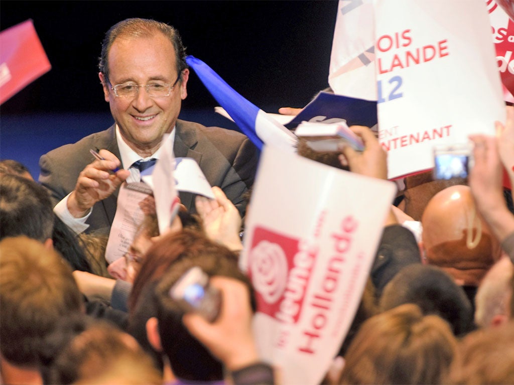 The Socialist Party candidate François Hollande signs autographs at the end of a rally in Besançon, eastern France