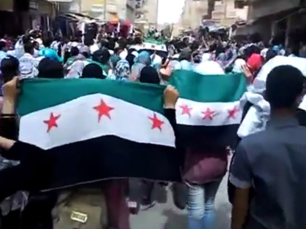 Syrians stage a rare show of defiance with rebel flags in Deir el-Zour yesterday