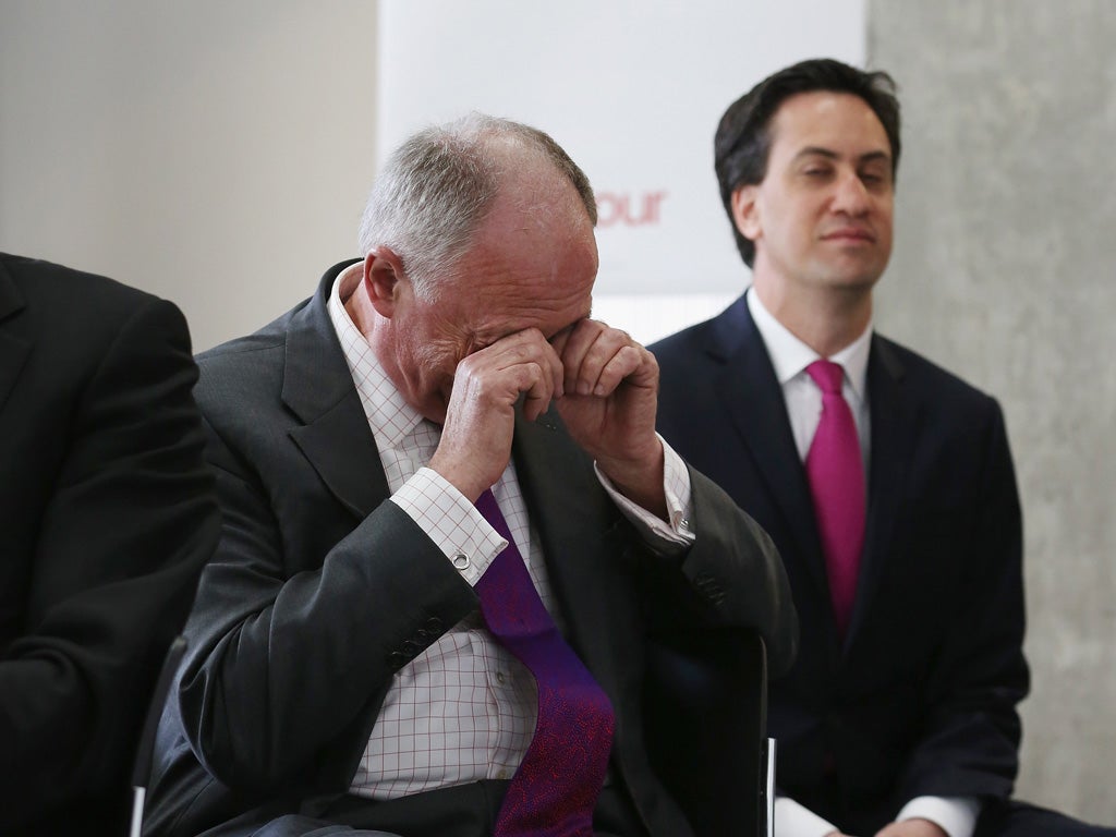 Ken Livingstone, the Labour candidate for Mayor of London, rubs his eyes before Ed Miliband as his mayoral promotional video is shown