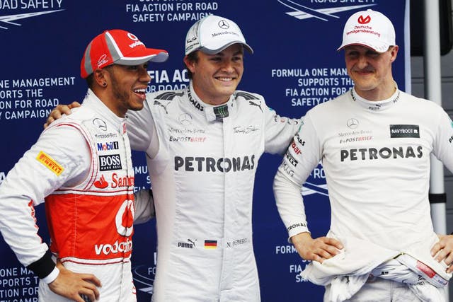 Mercedes driver Nico Rosberg, centre, celebrates with teammate Michael Schumacher, right, and Lewis Hamilton of McLaren after winning the qualifying session the Chinese Grand Prix in Shanghai