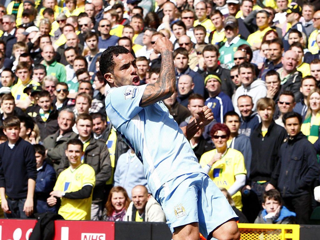 Carlos Tevez celebrates his hat-trick against Norwich