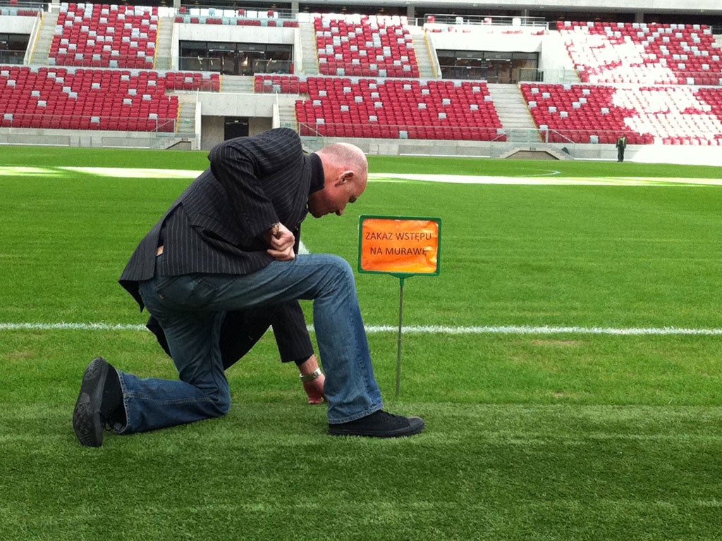 Turf accountant: Patrick Barclay tests the grass at Poland's National Stadium