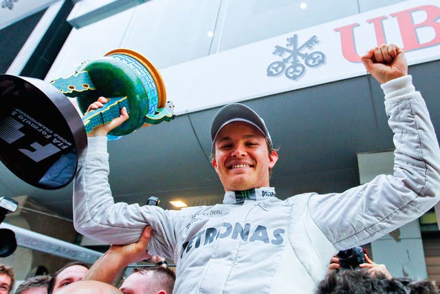 Triumphant Nico Rosberg raises his first grand prix winner’s trophy
