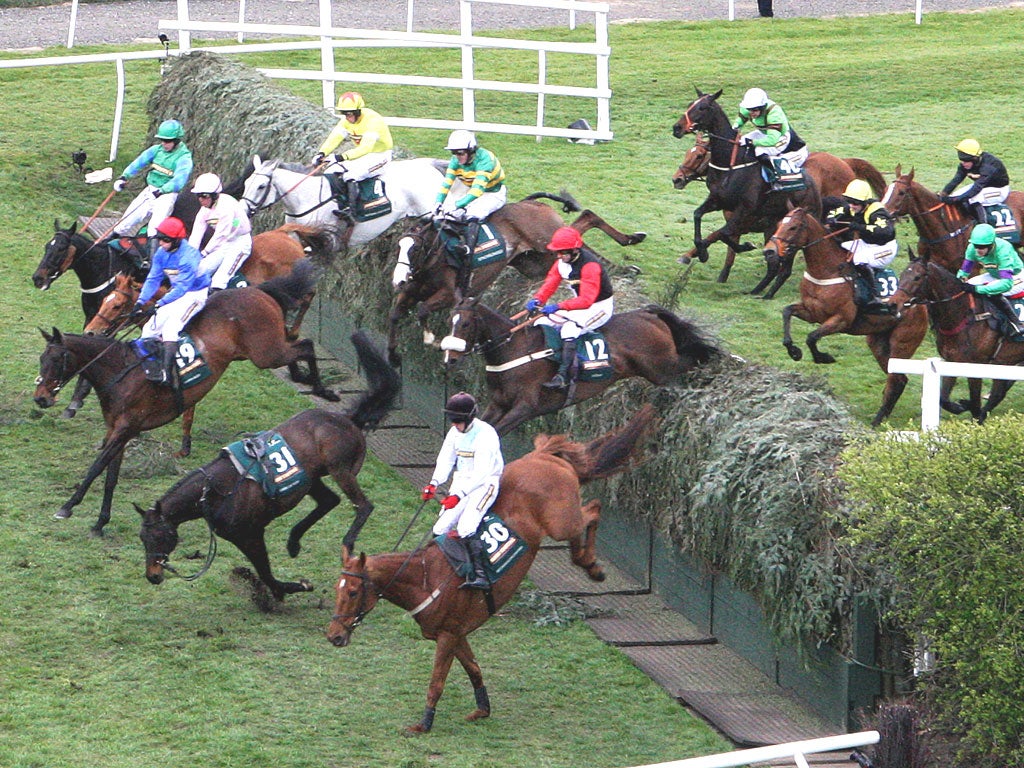 Synchronised, ridden by Tony McCoy (white cap, green and yellow hoops), falls at Becher’s