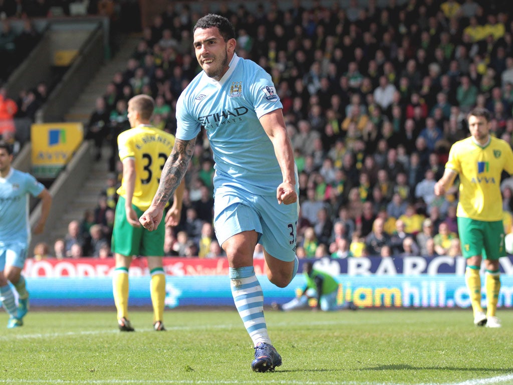 Carlos Tevez wheels away after getting his hat-trick with City’s fifth goal