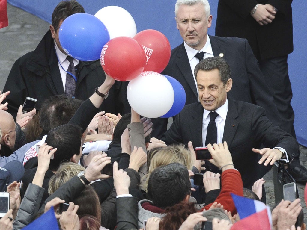 Sarkozy greets jubilant supporters before giving his speech in Paris
