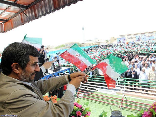 Ahmadinejad waving at supporters during a visit to island of Abu Musa