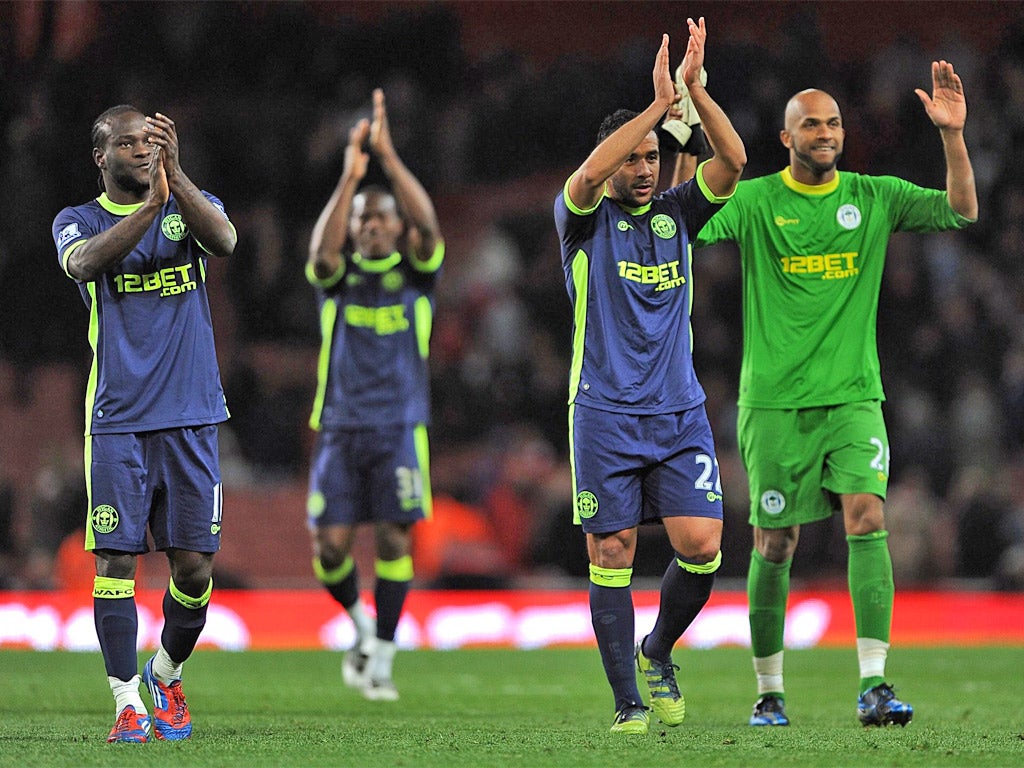 Wigan players applaud their fans after Monday's win