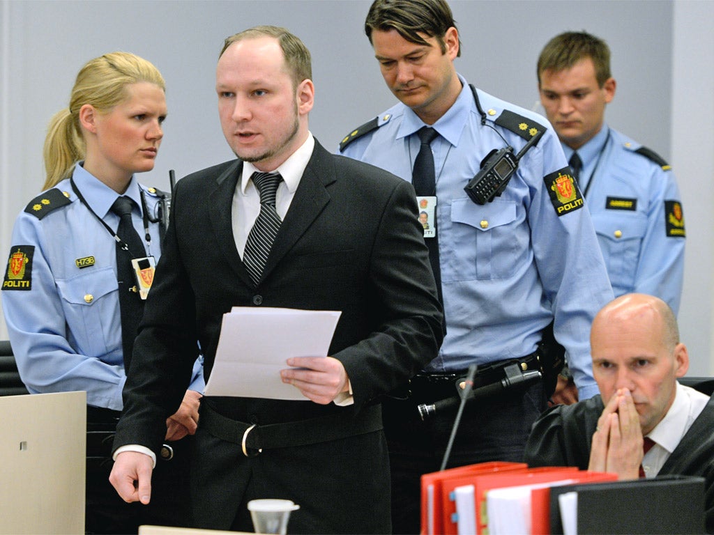 Anders Behring Breivik walks to take his seat in the witness box on day three of his murder trial in Oslo yesterday