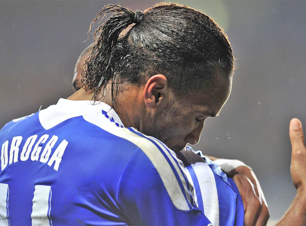 Didier Drogba takes a victory embrace at Stamford Bridge last night