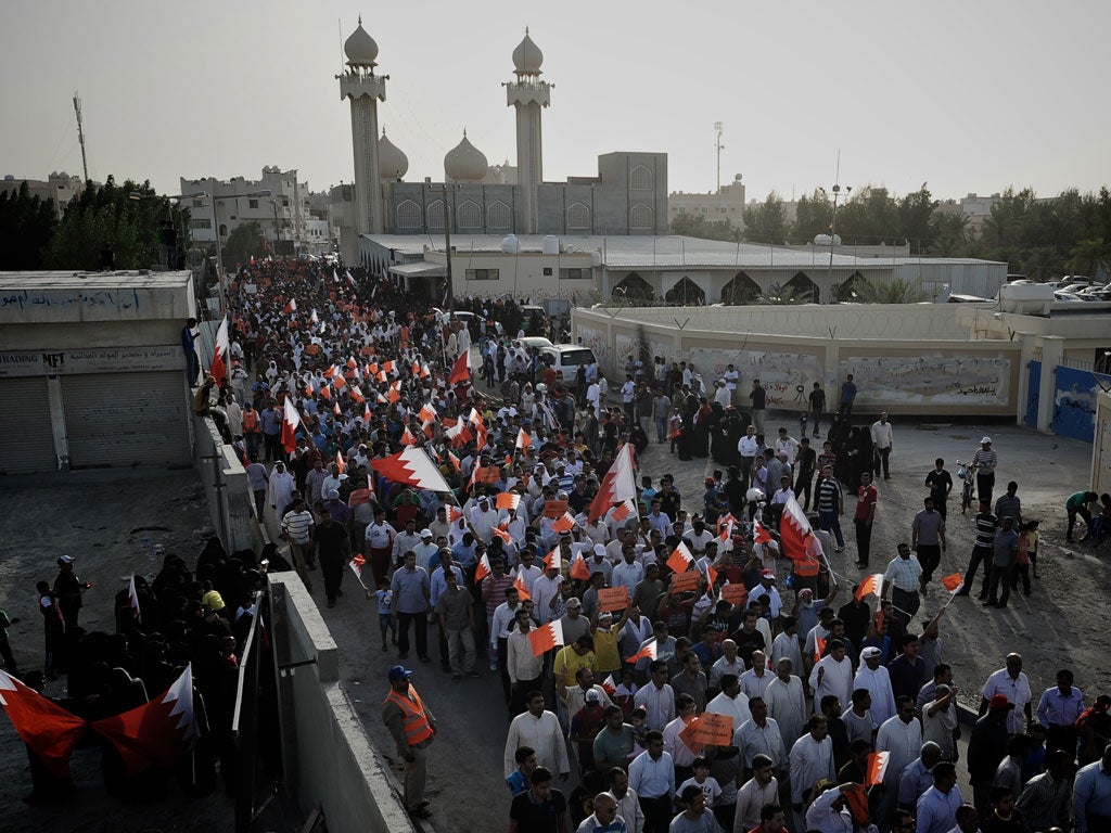 Bahraini Shiite Muslim democracy activists, waving national flags, take part in a demonstration calling for the canellation of the upcoming Bahrain Formula One Grand Prix