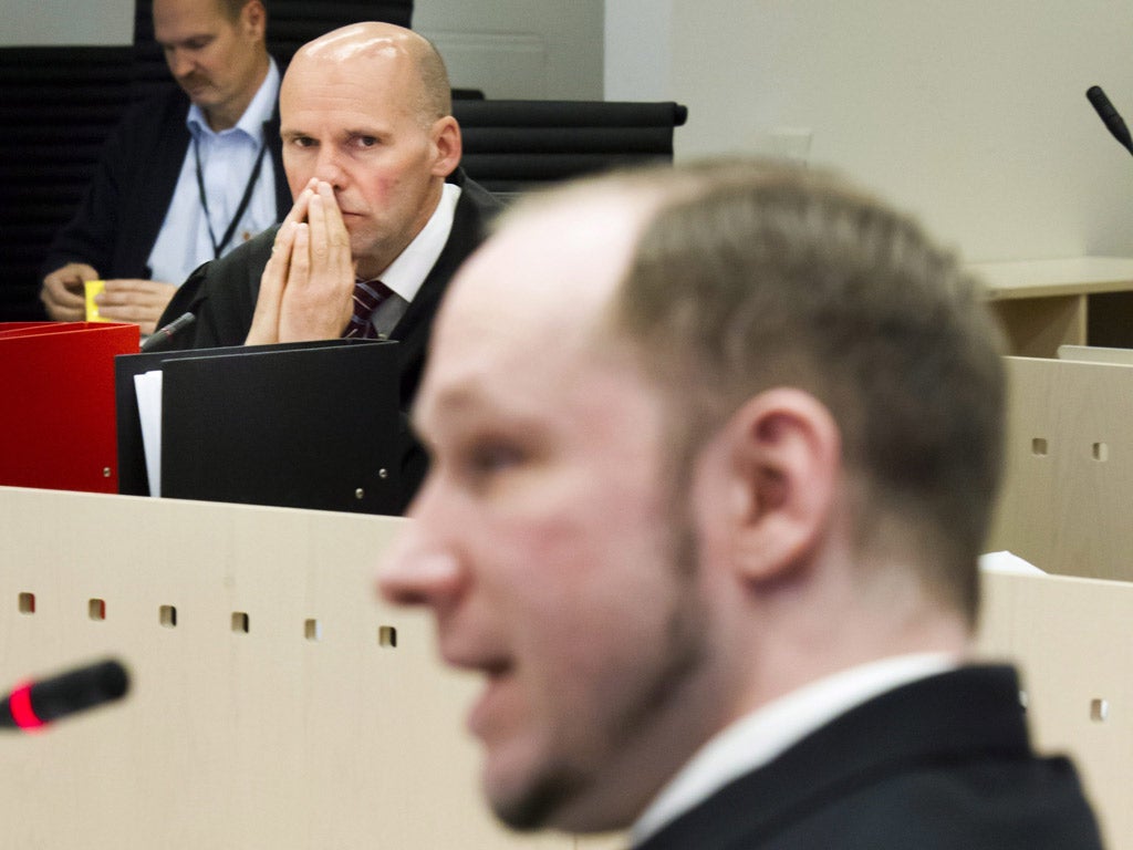Anders Behring Breivik is watched by his lawyer Geir Lippestad