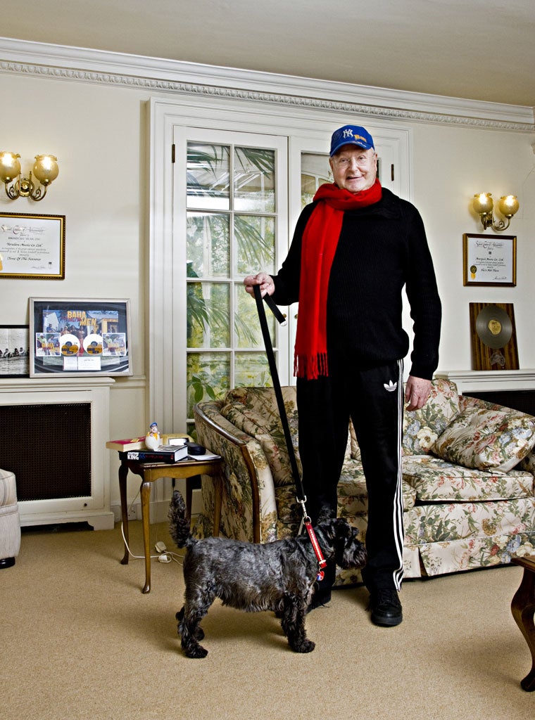 Who let the dogs out? Jonathan King at his west London home with his friend Jet, in front of gold discs of some of the hits he's presided over, including the Baha Men's number one