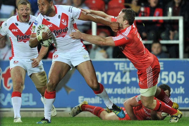 St Helens' Francis Melli holds off Widnes' Cameron Phelps
