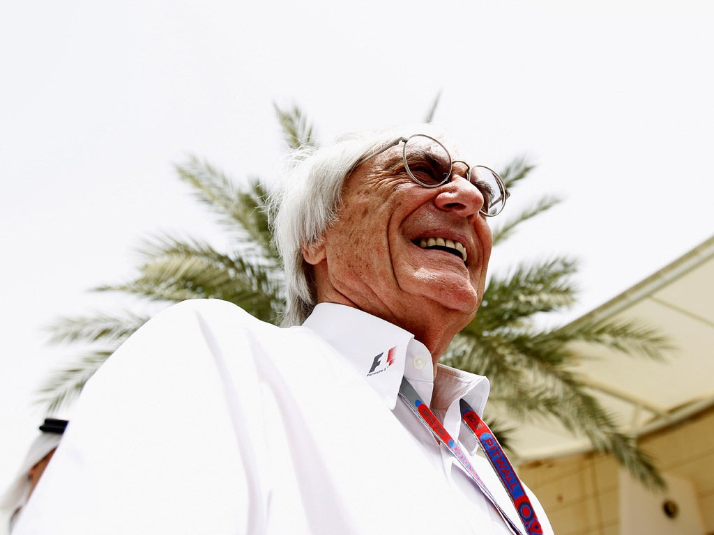 Grin and bear it: The Formula One supremo Bernie Ecclestone samples the atmosphere at the Bahrain Grand Prix