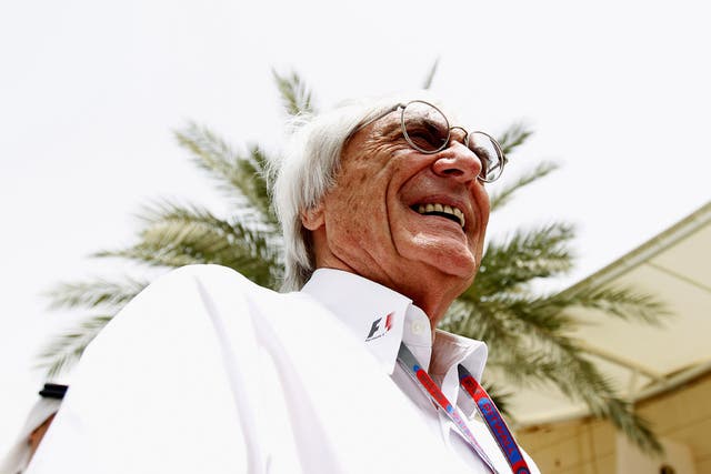 Grin and bear it: The Formula One supremo Bernie Ecclestone samples the atmosphere at the Bahrain Grand Prix