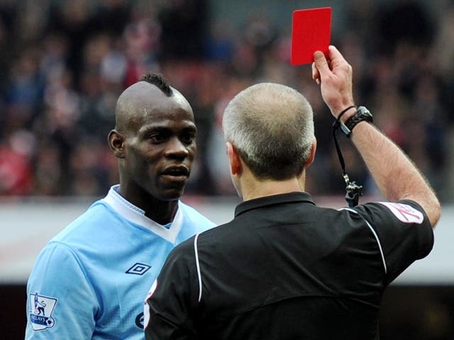 British referee giving Mario Balotelli a red card