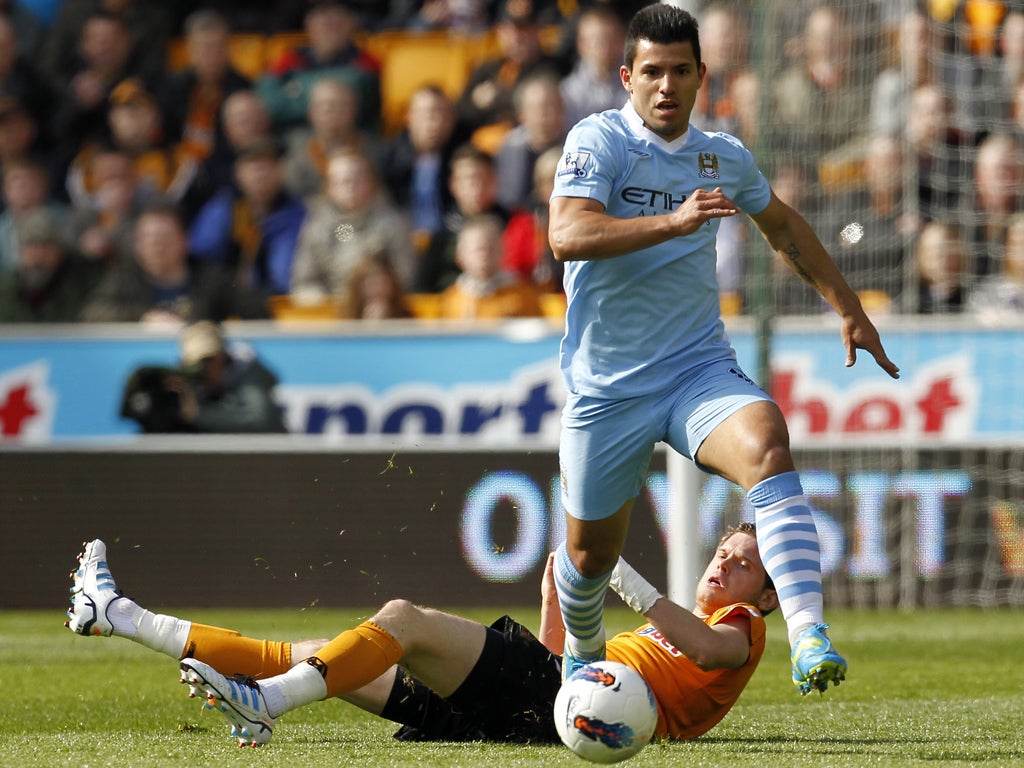 Manchester City striker Sergio Aguero skips past Wolves' Richard Stearman before hammering home the first goal