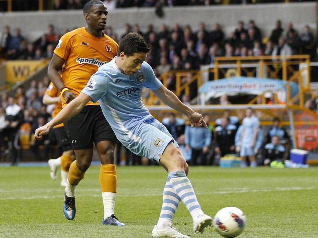 Manchester City’s Samir Nasri scores against Wolves. The result confirmed relegation for Wolves
manager Terry Connor and the club’s supporters