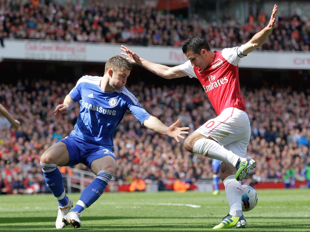 Chelsea’s Gary Cahill tangles with Arsenal striker Robin van Persie